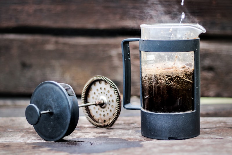 An espresso machine pulling a shot into a small cup with fresh crema on top.