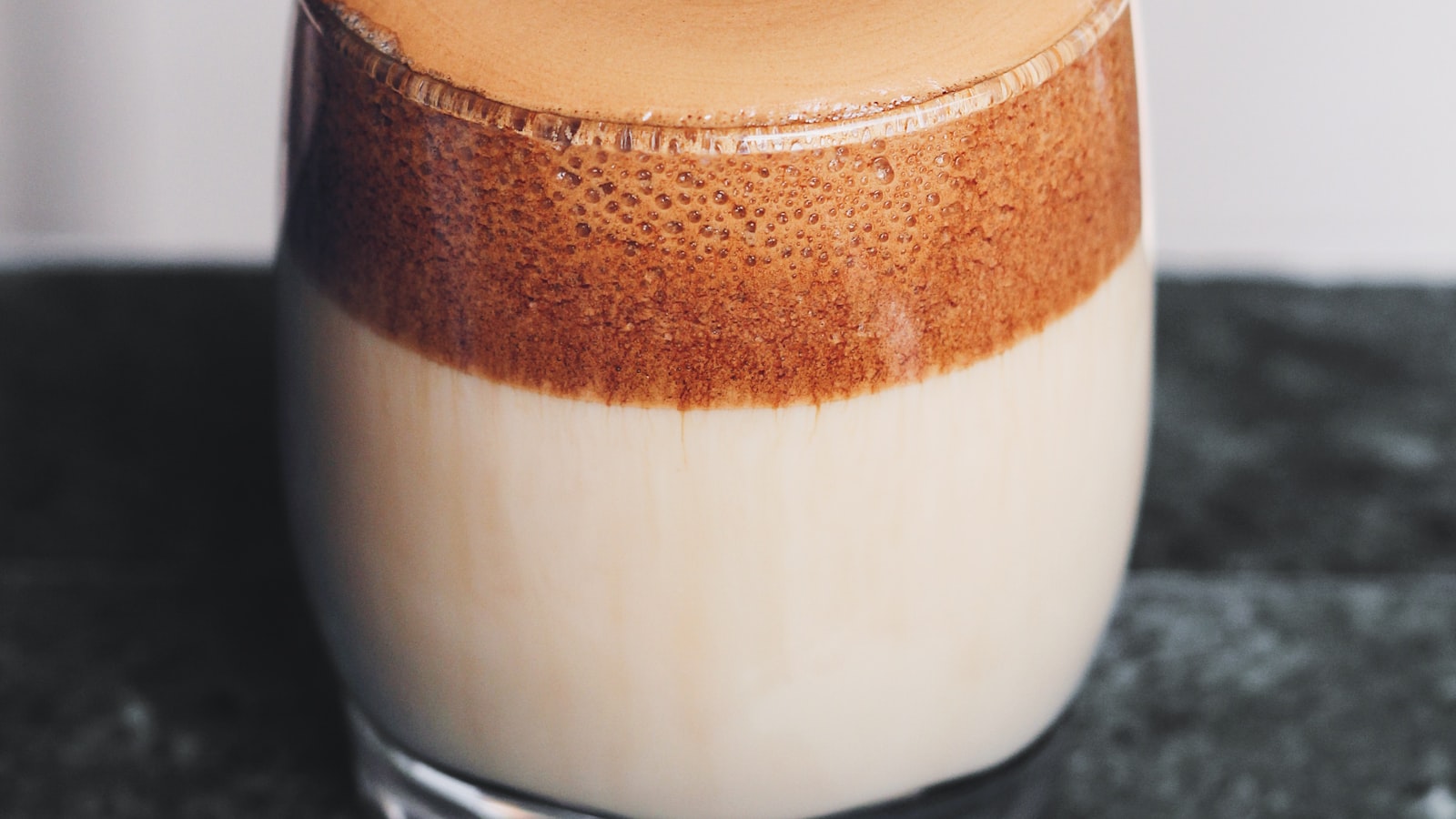 An AeroPress coffee maker sitting on a mug on a wooden kitchen surface.