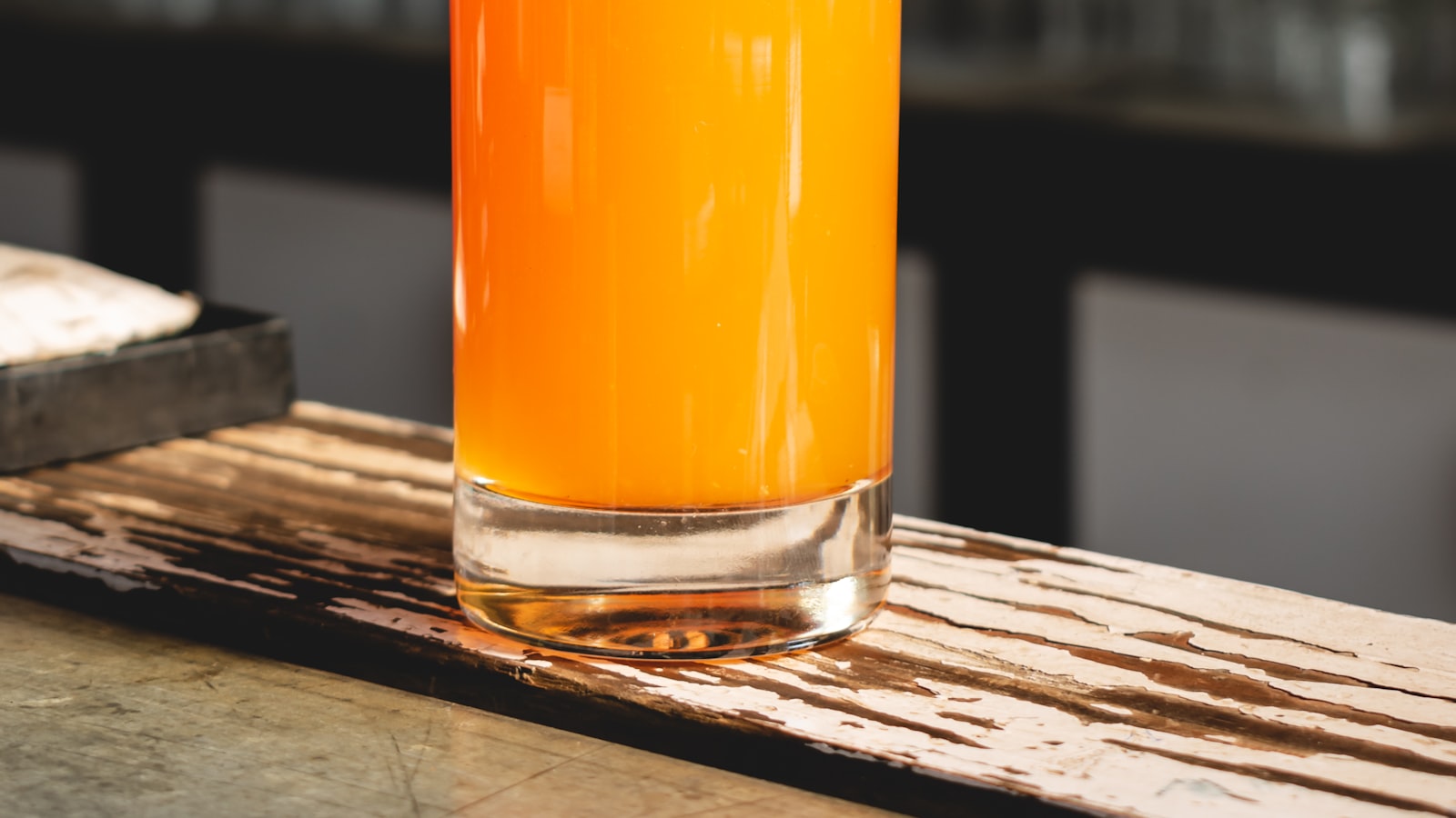 A tall glass of iced cold-brewed tea with condensation on the outside